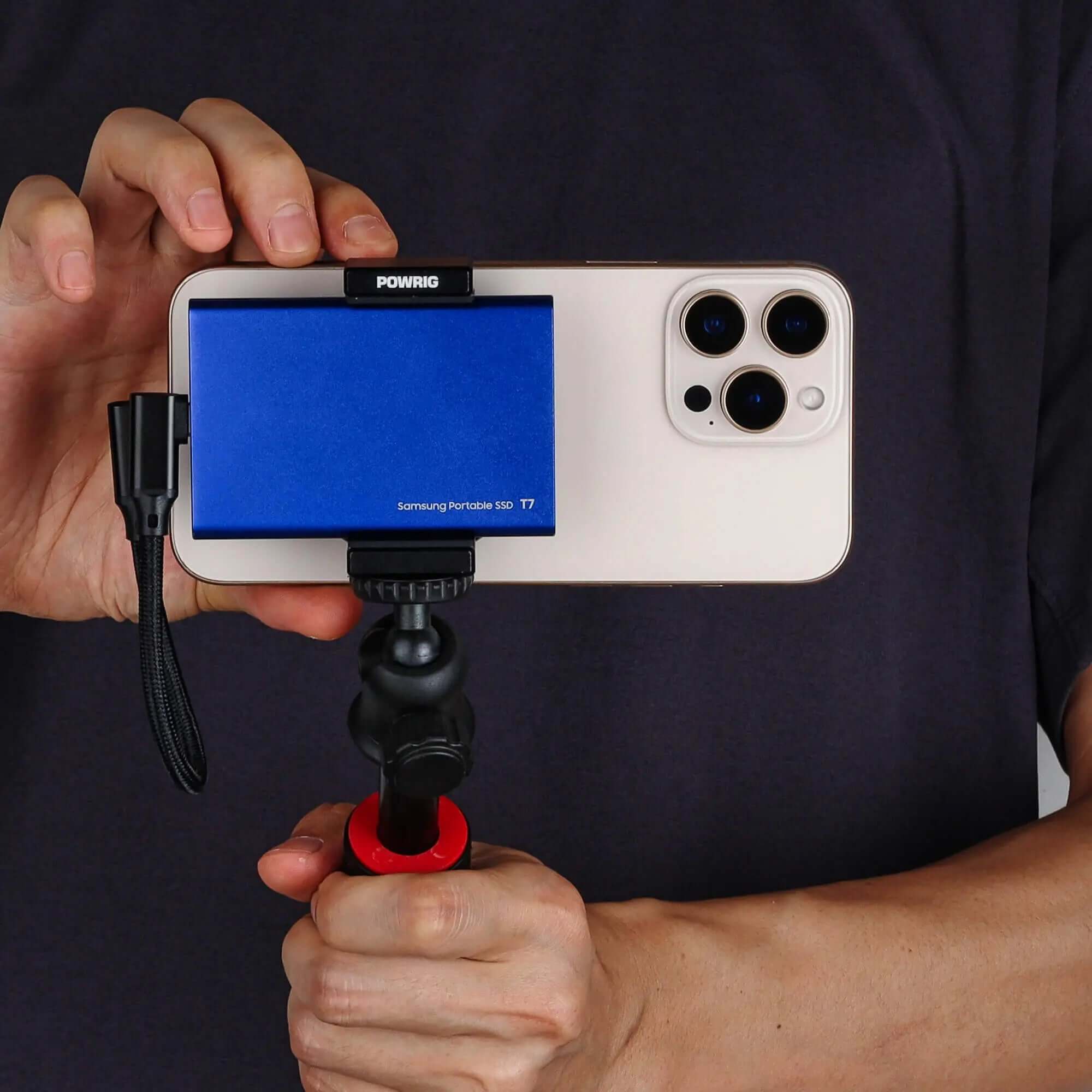 Filmmaker holding iPhone 16Pro with POWRIG MagSafe SSD mount for mobile videography