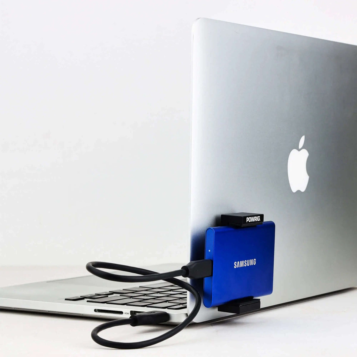 POWRIG Aluminum SSD Mount Clamp for MacBook - Secure Samsung T7/T9 portable SSD holder attached to laptop, ideal for video editing