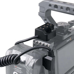 D-Tap power splitter and coiled cable in use on a professional Blackmagic camera rig for external power distribution