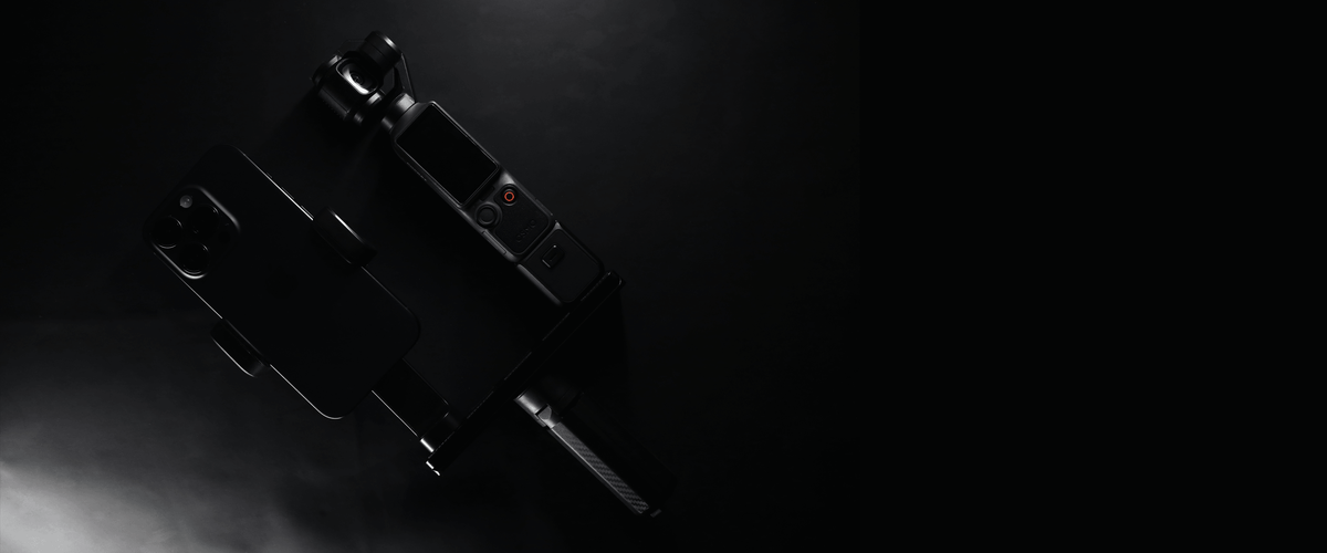 DJI OSMO Pocket 4 with a phone mount and lens attachment, shown in a dramatic low-key studio shot against a dark background.