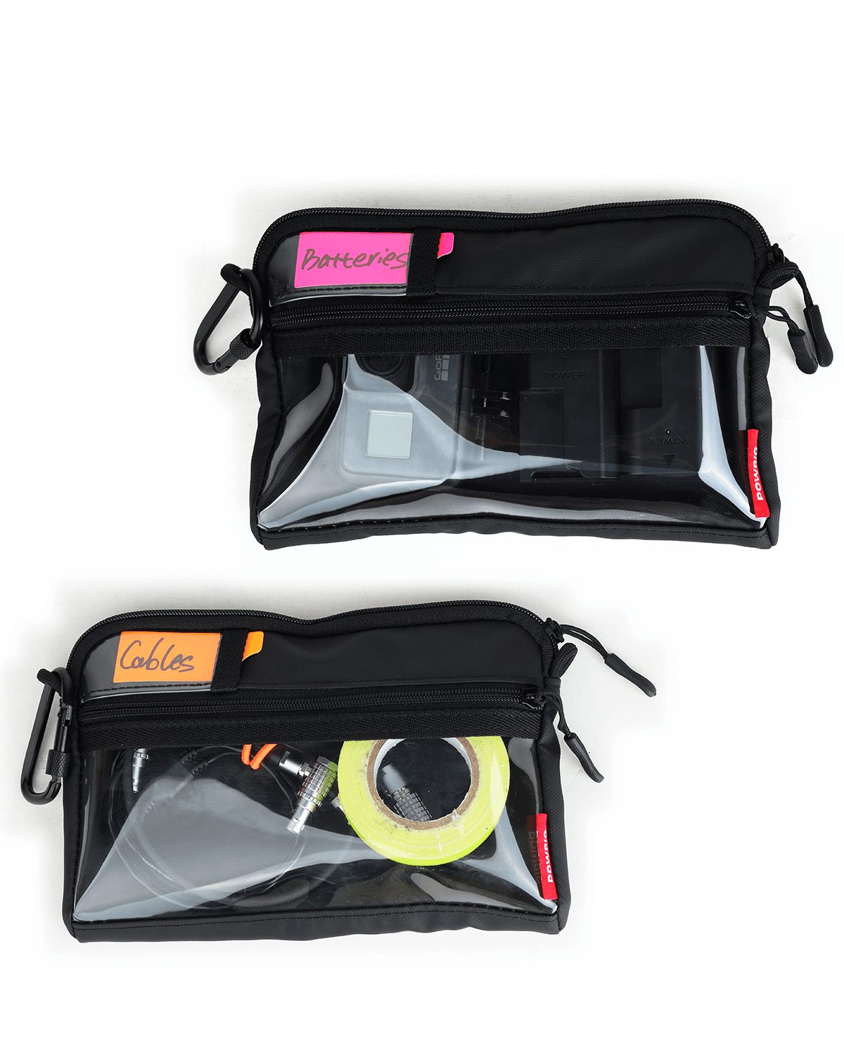 Two black zippered cable management sleeves with clear front panels, shown on a white background. The top sleeve is labeled 'Batteries' with a pink sticky note, and the bottom sleeve is labeled 'Cables' with an orange sticky note, both containing various electronic cables and accessories.