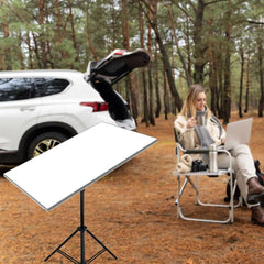 Outdoor camping setup with Starlink Gen 3 on tripod next to white SUV providing internet for laptop