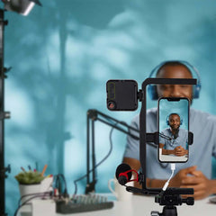Aluminum phone video rig in live streaming setup for podcast vlog recording with mic and LED fill lamp
